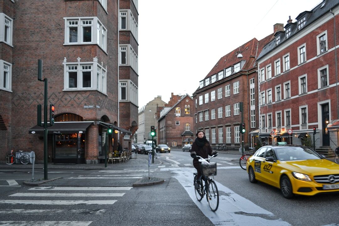 Cyclist crossing a rainy street in Copenhagen