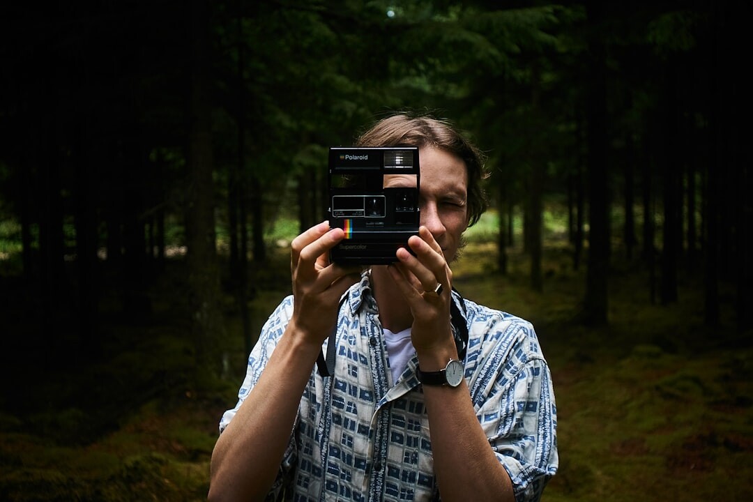 Portrait of a Danish male documentary photographer holding a camera