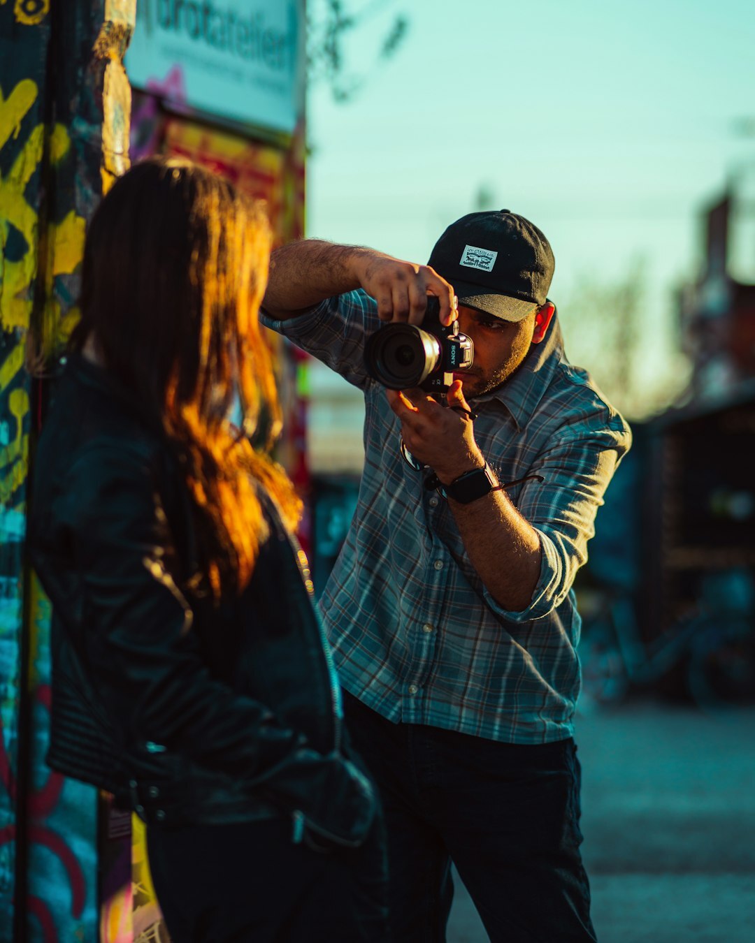 Photographer adjusting camera settings during an outdoor session